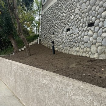 GR Landscaping - This is the front bed where they graded the dirt down and added some 50/50 soil mix for us to prepare for future planting. - Landscaping Near Me