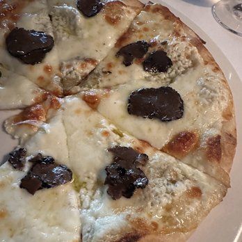 Timo - White pizza with BLACK & WHITE PIZZA - FRESH RICOTTA, MOZZARELLA AND PROVOLONE WITH SHAVED BLACK TRUFFLES - Italian Near Me - Sunny Isles Beach, Florida