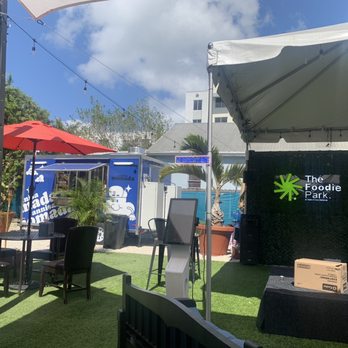 The Foodie Park - The stage and one of the food trucks - Food Court Near Me - Miami, Florida The Foodie Park - The stage and one of the food trucks - Food Court Near Me - Miami, Florida