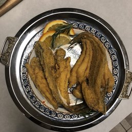 a plate of fried fish on a table
