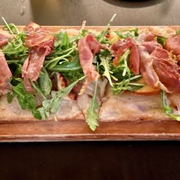 Prosciutto and arugula flatbread. Prosciutto and arugula flatbread.