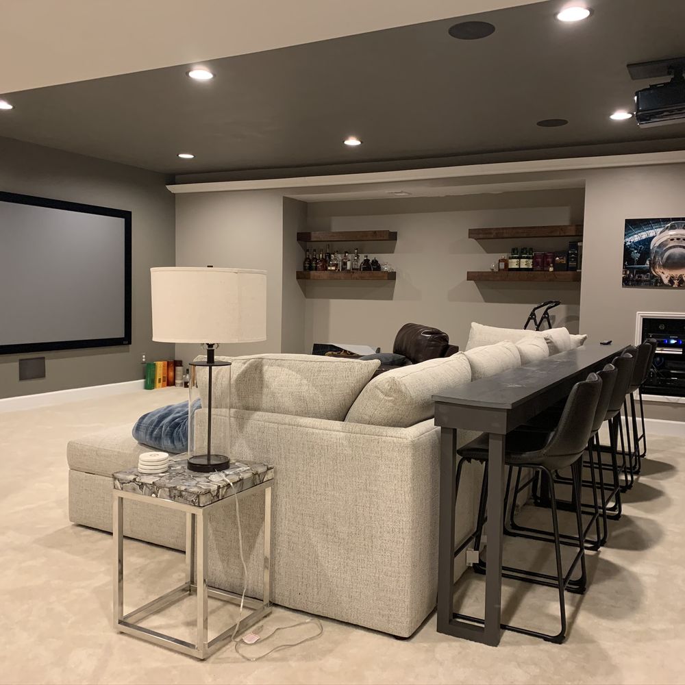 a living room with a large screen a living room with a large screen