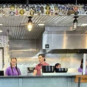 Tin Roof Tacos - Bar with military patches above - Tacos Near Me - Boise, Idaho Tin Roof Tacos - Bar with military patches above - Tacos Near Me - Boise, Idaho