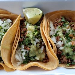 Cocodrilo Tacos & Hot Dogs - Left Taco is Steak, 2 on the right are chorizo Both topped with green sauce (mild) & red sauce (spicy) 3 for $10, comes with a drink