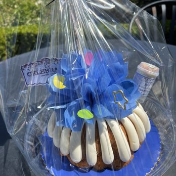 Nothing Bundt Cakes - "Celebrate" themed 8" birthday Bundt cake with a star sparkler candle and the "Columbia blue" colored bow (Easter - April 2026) - Bakeries Near Me - Ventura, California Nothing Bundt Cakes - "Celebrate" themed 8" birthday Bundt cake with a star sparkler candle and the "Columbia blue" colored bow (Easter - April 2026) - Bakeries Near Me - Ventura, California