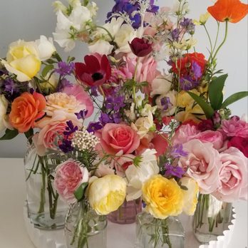 Flower Box Studios - A gathering of small bottle arrangements - Floral Designers Near Me Flower Box Studios - A gathering of small bottle arrangements - Floral Designers Near Me