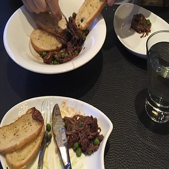 Globe Cafe and Tapas Bar - Lamb shoulder with garlic bread - Tapas/Small Plates Near Me - Big White Mountain, British Columbia Globe Cafe and Tapas Bar - Lamb shoulder with garlic bread - Tapas/Small Plates Near Me - Big White Mountain, British Columbia