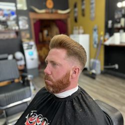 Skin fade pompadour.