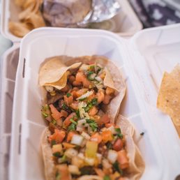 Two tacos, one al pastor one carne asada