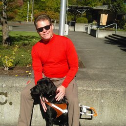 a man sitting on a bench with his dog a man sitting on a bench with his dog