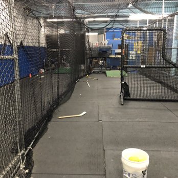 The Batting Cage - A cage with a machine and to the left is the cage without the machine. - Recreation Centers Near Me - mineloa, New York