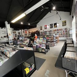 First Day Vinyl - A lot of Vinyls, posters, cassettes, CD's, vinyl cleaners and covers, and puzzles.