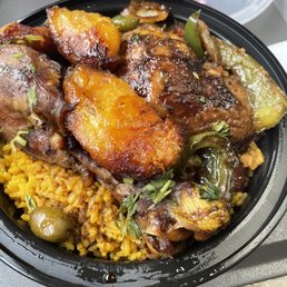 Pollo guisado- dark meat with rice and gandules and fried platains. Delicious Pollo guisado- dark meat with rice and gandules and fried platains. Delicious