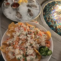 The appetizers. Oysters and shrimp nachos. The appetizers. Oysters and shrimp nachos.