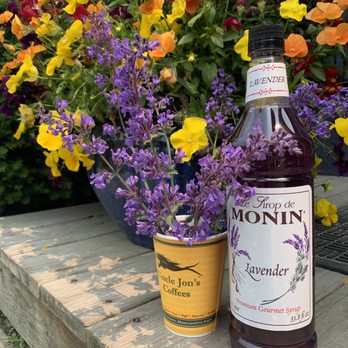 Uncle Jon's Coffees - a bottle of monin lavender syrup next to a flower pot - Coffee & Tea Near Me - Mattapoisett, Massachusetts Uncle Jon's Coffees - a bottle of monin lavender syrup next to a flower pot - Coffee & Tea Near Me - Mattapoisett, Massachusetts