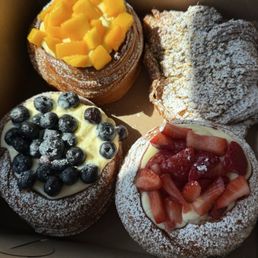 Strawberry, mango and blueberry pastry and a pistachio croissant. Strawberry, mango and blueberry pastry and a pistachio croissant.