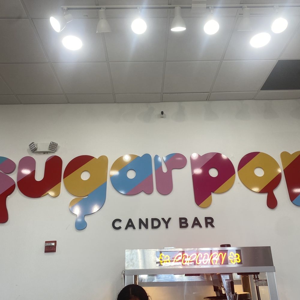 SugarPop Candy bar - a woman standing in front of the sign - Candy Stores Near Me - Long Branch, New Jersey