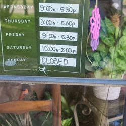 Martha's Florals - Hours posted in window.