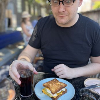 True Laurel - Thrilled partner ready to dig into Grilled Cheese omelet sandwich with sage sausage - Cocktail Bars Near Me - San Francisco, California True Laurel - Thrilled partner ready to dig into Grilled Cheese omelet sandwich with sage sausage - Cocktail Bars Near Me - San Francisco, California
