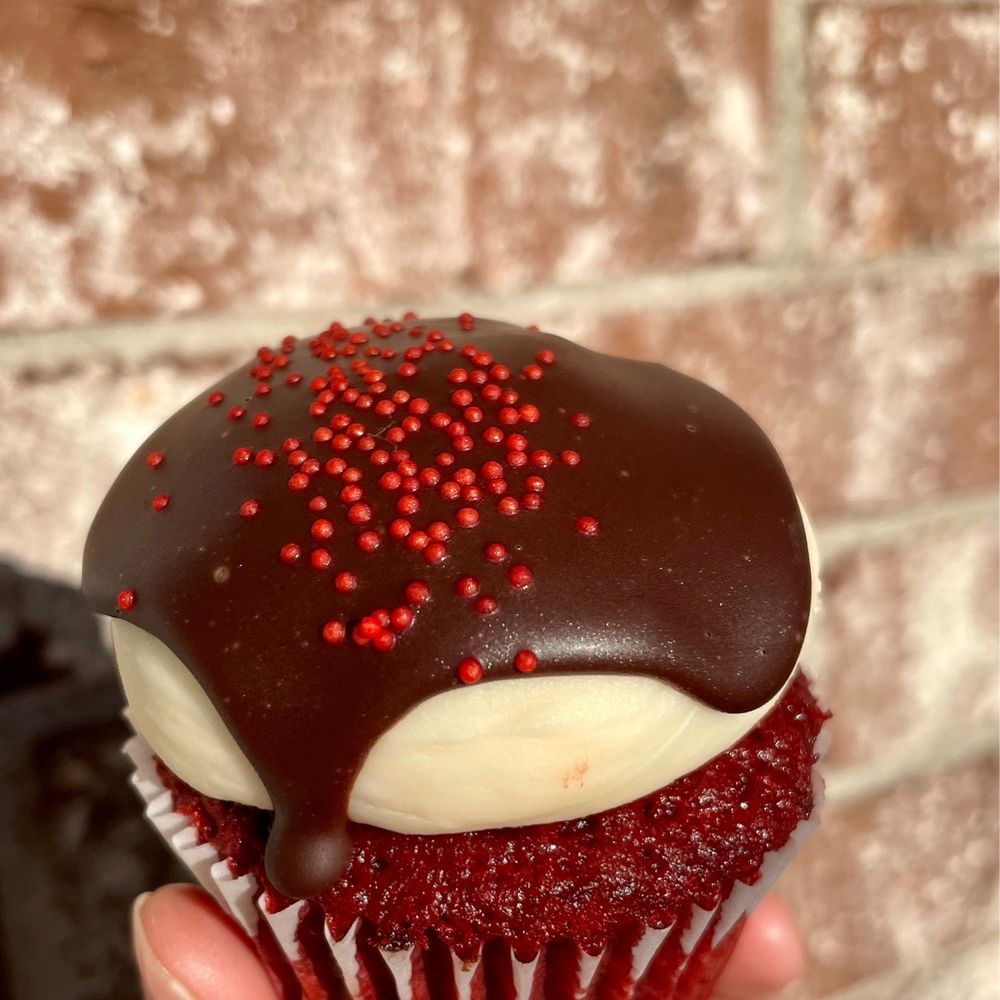 Wildflour Pastry - a hand holding a cupcake - Desserts Near Me - Charleston, South Carolina Wildflour Pastry - a hand holding a cupcake - Desserts Near Me - Charleston, South Carolina