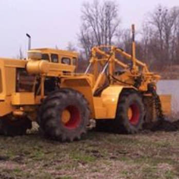Shankster Bros - a large yellow tractor in a field - Septic Services Near Me - Silver Lake, Indiana Shankster Bros - a large yellow tractor in a field - Septic Services Near Me - Silver Lake, Indiana