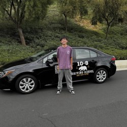 10-8 Driving School - Me in front of the 10-8 car after completing their course