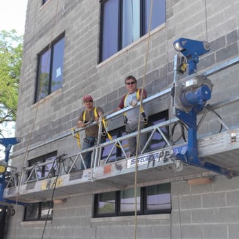 A Peter Construction - two men on a scaffolding platform - General Contractors Near Me A Peter Construction - two men on a scaffolding platform - General Contractors Near Me