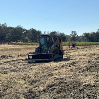 Drumm Construction - Using the skeleton rake attachment to remove debris after pulling grapevine stumps. - Excavation Services Near Me - Yuba City, California