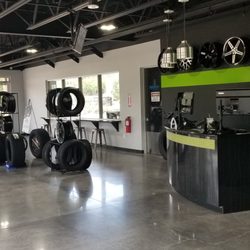 Tires by Design- Friendswood - Comfortable, sleek updated showroom. Where you can work while you wait, with charging stations.