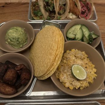 Bartaco - Appetizer tray with street corn, plantains, guacamole, a cucumber salad, and corn tortillas - Tacos Near Me - Jacksonville, Florida
