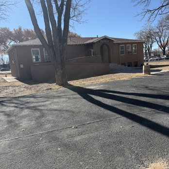 Menaul School - Where I first watch MTV in the mid 80's - A brown, single-story building with a ramp and stairs, situated in a parking lot with leafless trees and parked cars nearby. - Elementary Schools Near Me - Albuquerque, New Mexico
