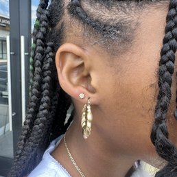 Pediatric Piercing with a dainty little daisy earring