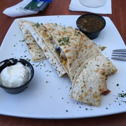 a plate of quesadillas with sour cream a plate of quesadillas with sour cream
