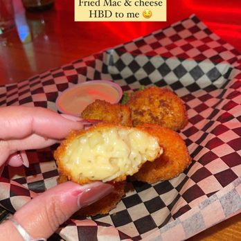 Kelly's Olympian - a hand holding a fried mac and cheese sandwich - Dive Bars Near Me - Portland, Oregon Kelly's Olympian - a hand holding a fried mac and cheese sandwich - Dive Bars Near Me - Portland, Oregon