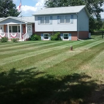 Clean Cuts Lawn Care - a house with a lawn mowed - Landscaping Near Me