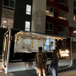 two people ordering food from a food truck two people ordering food from a food truck