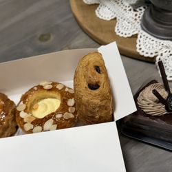 Paris Baguette - Left to right: Chausson aux Pommes, Cream Cheese pastry, Pain Au Chocolat, and Ganache Cream cake slice