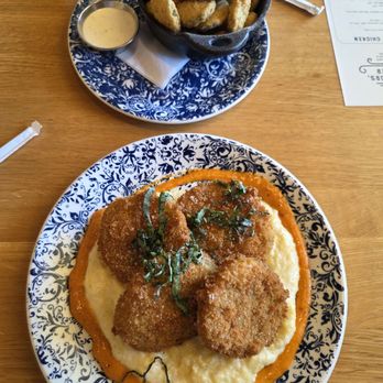 Tupelo Honey Southern Kitchen & Bar - Famous Fried Green Tomatoes over a bed of Goat Cheese Grits & Fried Pickles - New American Near Me - Huntsville, Alabama Tupelo Honey Southern Kitchen & Bar - Famous Fried Green Tomatoes over a bed of Goat Cheese Grits & Fried Pickles - New American Near Me - Huntsville, Alabama