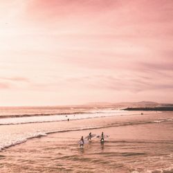 Go Luxe Travel - Surfing at sunset...