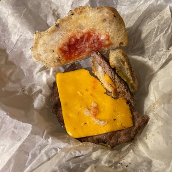 Nicky's Lionshead Taverns - a cheeseburger with a bite taken out of it - New American Near Me - De Pere, Wisconsin