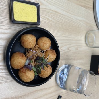 Yunta Nikkei - Yuca Balls!!!! Yuca balls stuffed with andean cheese and served with aji carretilleto sauce. - Peruvian Near Me - Charlotte, North Carolina