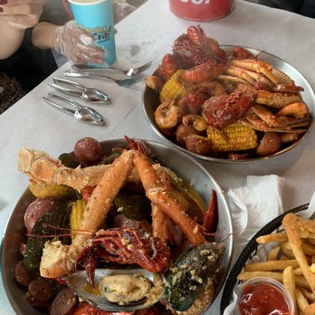 Storming Crab - Bottom platter has the garlic butter sauce and the top platter as the spicy cajun sauce! - Seafood Near Me - Fort Wayne, Indiana
