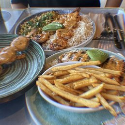ATLANTIC SALMON Cajun style with rice & fries . Shrimp skewer with rice & corn Cajun style