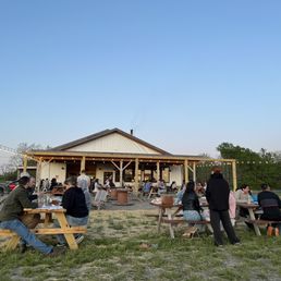people sitting at picnic tables