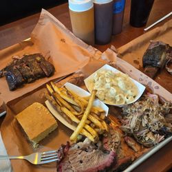 3 meat plate: pork ribs (top left), fatty brisket (bottom left), + pulled pork (in middle) with beef rib (most right tray)