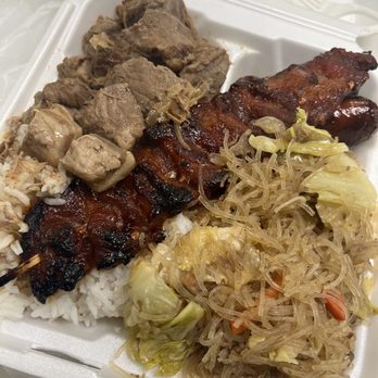 Filipino Express - Half rice, half pancit, pork adobo, pork skewer, and two sausages. - Filipino Near Me - Buena Park, California Filipino Express - Half rice, half pancit, pork adobo, pork skewer, and two sausages. - Filipino Near Me - Buena Park, California