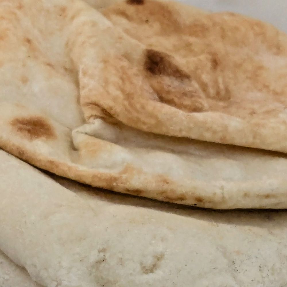 Abdallah’s Lebanese Cafe - 4 pieces of pita that comes with the large hummus - Cafes Near Me - Houston, Texas Abdallah’s Lebanese Cafe - 4 pieces of pita that comes with the large hummus - Cafes Near Me - Houston, Texas
