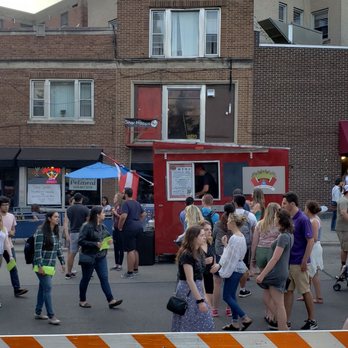 El Wiscorican - a crowd of people walking on a street - Food Trucks Near Me - Madison, Wisconsin