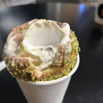 Twisted Rolls Chimney Cake - Pistachio Chimney Cone half eaten. - Ice Cream & Frozen Yogurt Near Me - Ballwin, Missouri