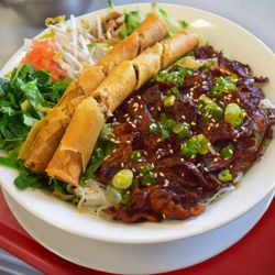 Quan Ngon Delicious Vietnamese Restaurant - Deluxe Grilled Pork Vermicelli, comes with juicy lemongrass grilled pork and 2 spring rolls, all for 12.95!